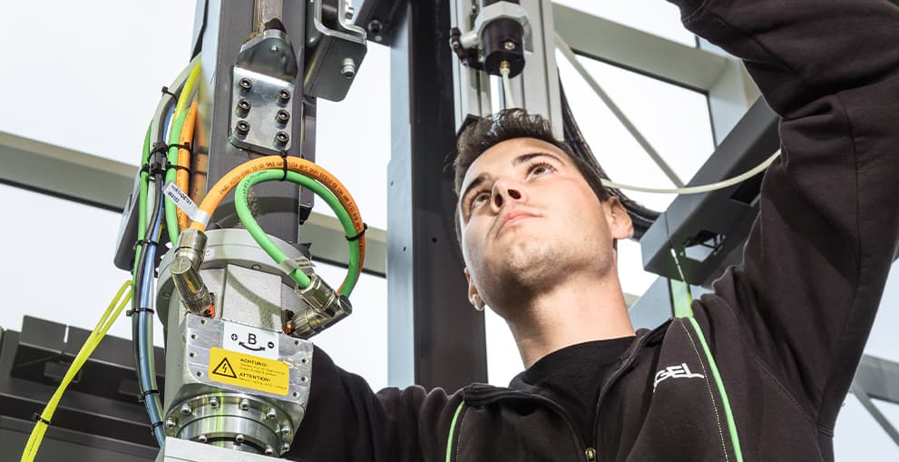 Technician servicing injection moulding equipment